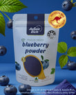 Aussie Rich blueberry powder  freeze-dried in a package with blueberries around on a blue background