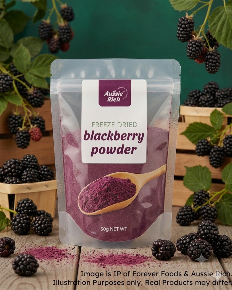 A stand-up pouch of Aussie Rich Freeze Dried Blackberry Powder, surrounded by fresh blackberries, green leaves, and wooden crates on a rustic wooden surface against a dark green background.