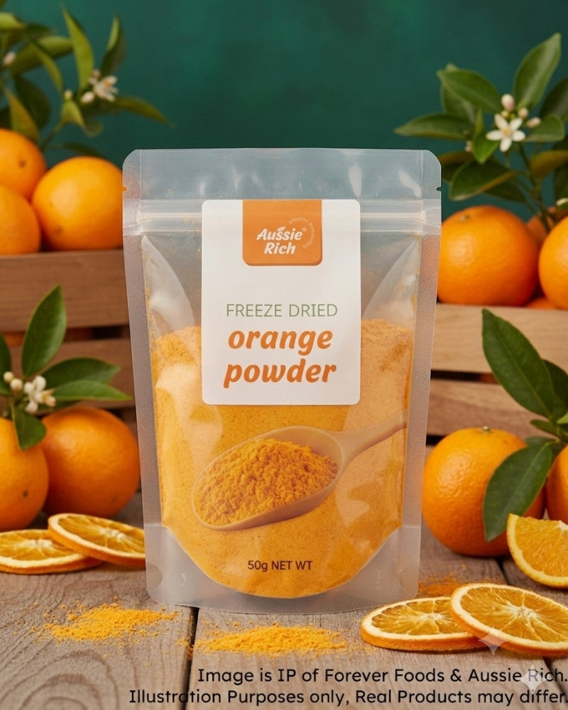 A stand-up pouch of Aussie Rich Freeze Dried Orange Powder centered on a rustic wooden surface, surrounded by whole oranges, sliced oranges, and green leaves against a dark green background.