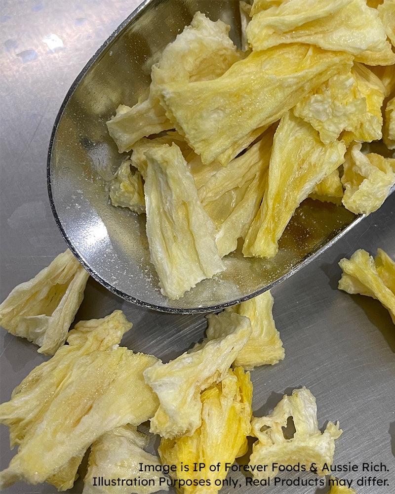 Freeze Dried pineapples in a metal scoop on a metallic tray