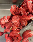 Dreid Strawberry Slices on a steel tray and serving spoon
